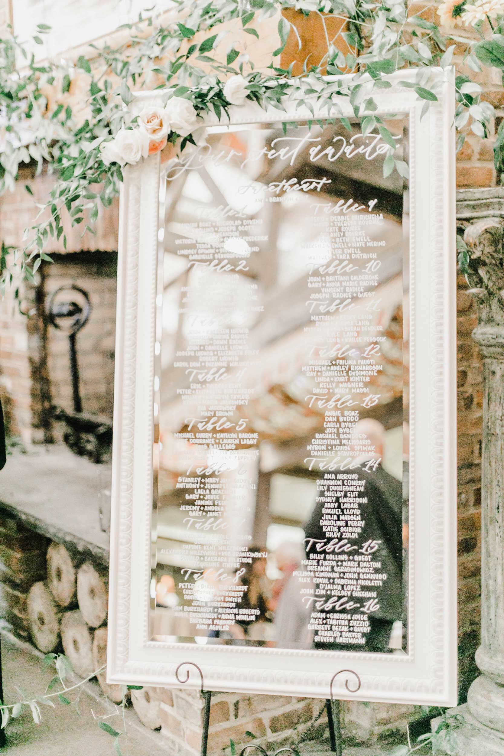 Modern mirror seating chart with calligraphy