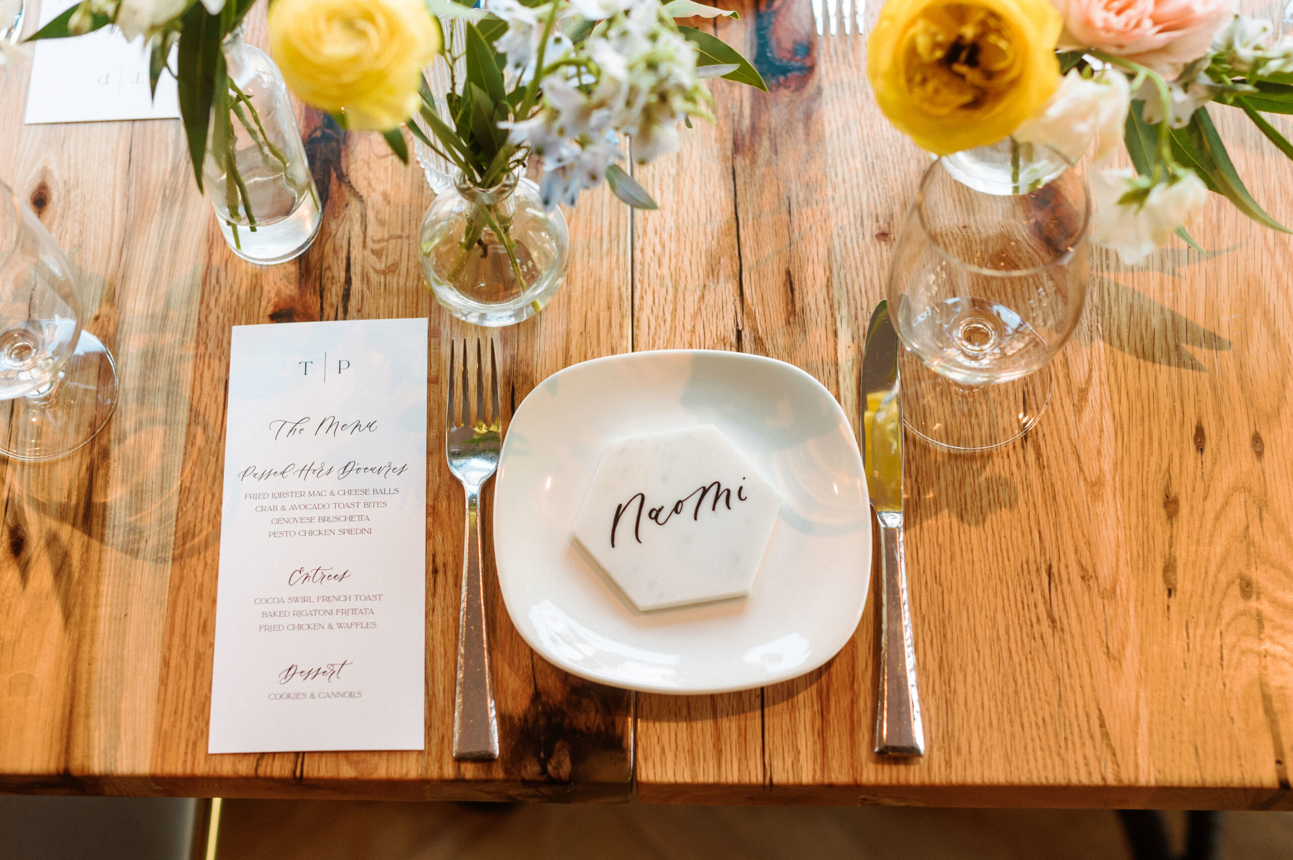 Chic place setting with personalized name tile, floral accents, and elegant printed wedding menu- calligraphy business from scratch