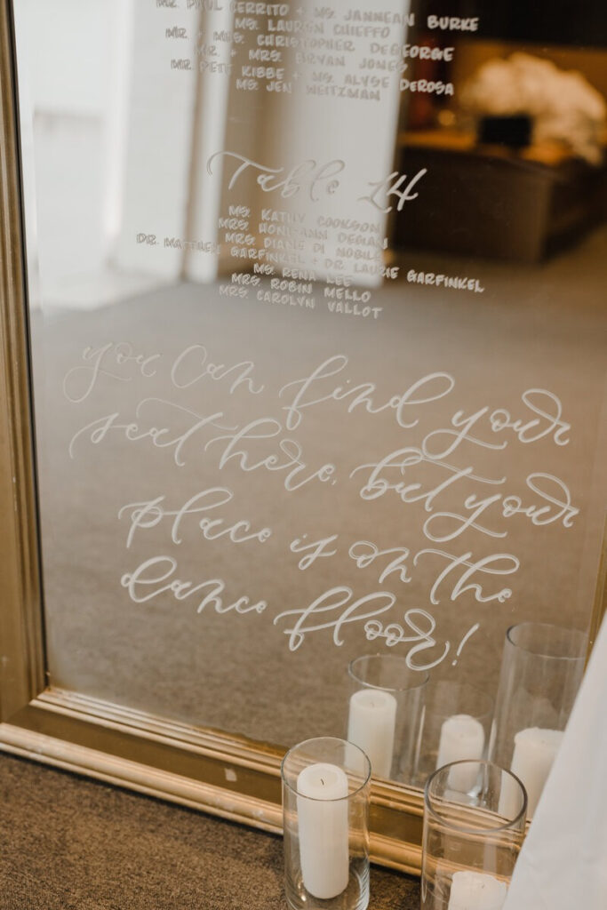  Mirror seating chart with white calligraphy, a fun message, and a custom touch that shows how to scale your handmade business.