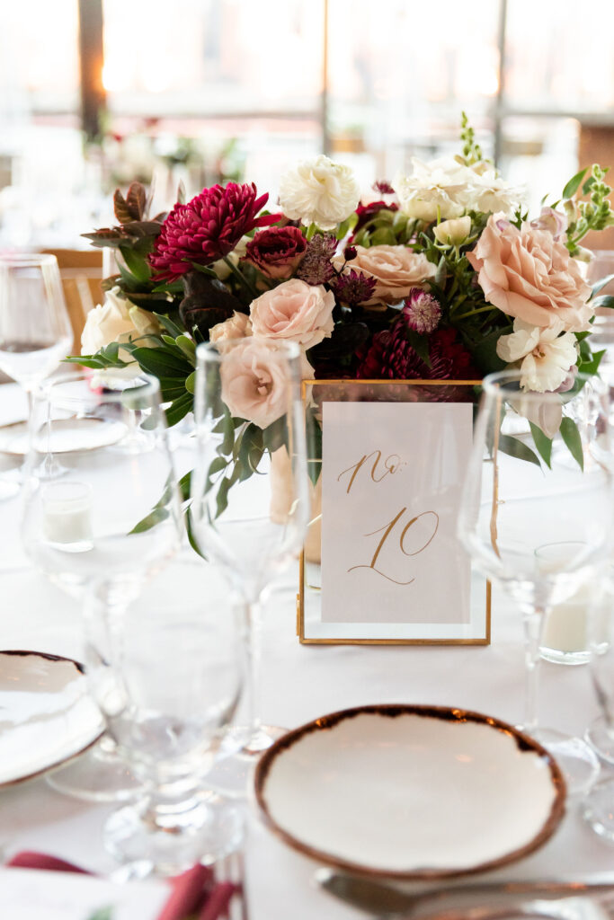 Wedding table setting with floral centerpiece and calligraphy table number—an example of partnering with wedding planners as a calligrapher.







